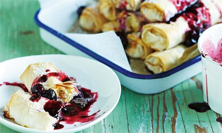 Delicious ricotta and sultana filo rolls with berry salsa